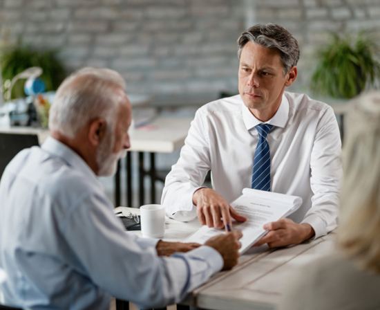 A disability advocate helping an older man.